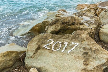 Number 2017 on the rocks off the coast, holiday backgroundの写真素材