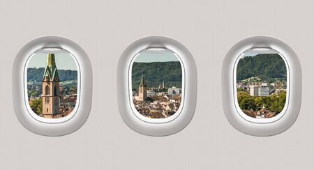 Looking out the windows of a plane to the city of Zurich, Switzerlandの写真素材