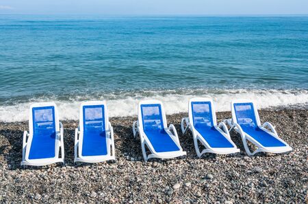 Sunbathing blue beds on the beach near seaの写真素材