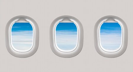 Looking out the windows of a plane to the beautiful blue sky and cloudsの写真素材