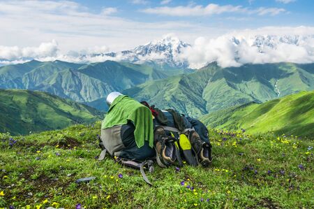 Drying towel and shoes on backpack on a background of mountains, Georgia (Svaneti)の写真素材