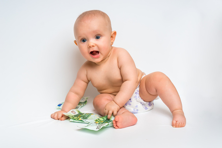 Adorable baby with euro bills money isolated on white backgroundの写真素材