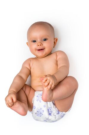 Cute baby in diaper lying on back isolated on white backgroundの写真素材