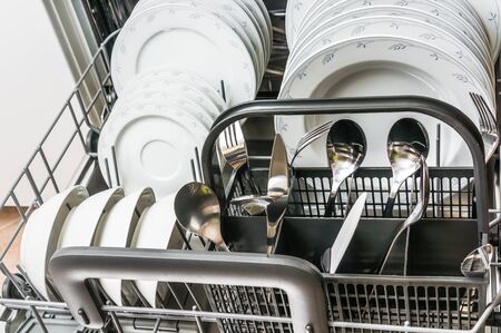 Open dishwasher with clean dishes after cleaning process - selective focusの写真素材