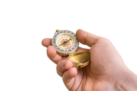 Antique brass compass in a hand isolated on white backgroundの写真素材