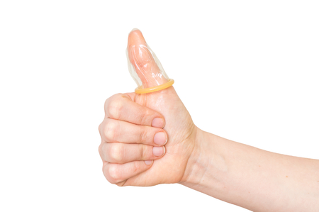 Condom on female thumb isolated on white backgroundの写真素材
