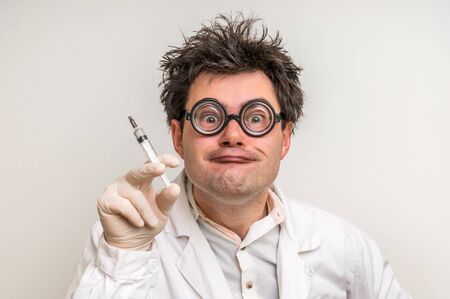 Young crazy doctor performing experiments in hospitalの写真素材