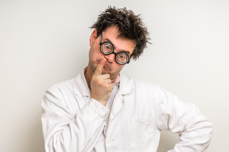 Crazy scientist with glasses thinking about his experimentの写真素材