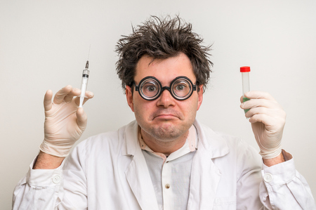 Young crazy scientist performing experiments in laboratoryの写真素材