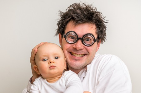 Crazy doctor with newborn baby in his hands - healthcare conceptの写真素材
