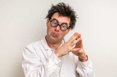 Crazy scientist with glasses thinking about his experimentの写真素材