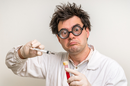 Young crazy scientist performing experiments in laboratoryの写真素材