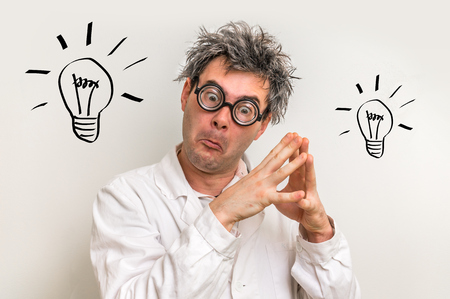 Crazy scientist got the great idea in laboratory with bulb symbolの写真素材