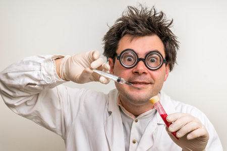 Young crazy scientist performing experiments in laboratoryの写真素材