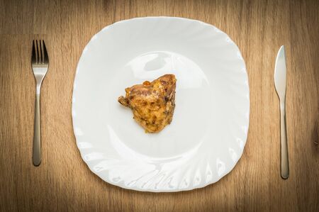 One piece of chicken on white plate - diet conceptの写真素材