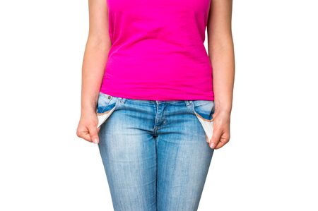 Young woman pulling out empty pockets isolated on white backgroundの写真素材