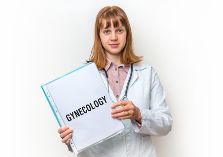 Female doctor showing medical clipboard with written text: Gynecology - isolated on white backgroundの写真素材