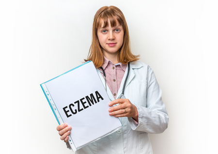 Female doctor showing medical clipboard with written text: Eczema - isolated on white backgroundの写真素材