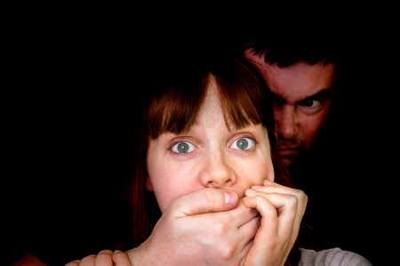 Man covering woman's mouth so she couldn't scream - abuse and violence conceptの写真素材