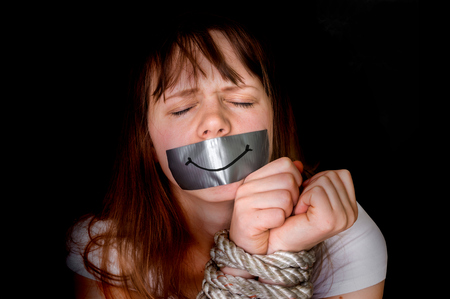 Tied rope hands of kidnapped woman isolated on black - violence conceptの写真素材