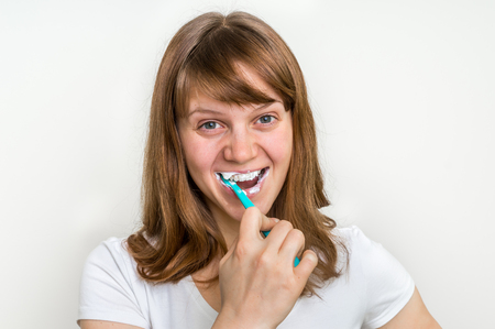 Woman brushing her teeth with toothbrush in the morning - dental care conceptの写真素材