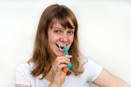 Woman brushing her teeth with toothbrush in the morning - dental care conceptの写真素材