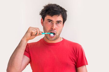 Young man brushing teeth in the morning - dental hygieneの写真素材