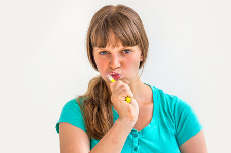 Young lady brushing teeth in the morning - dental hygiene