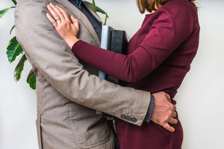Man touching woman's loin - sexual harassment in business officeの写真素材