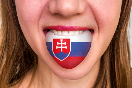 Woman with slovakian flag on the tongue - learning a foreign languageの写真素材
