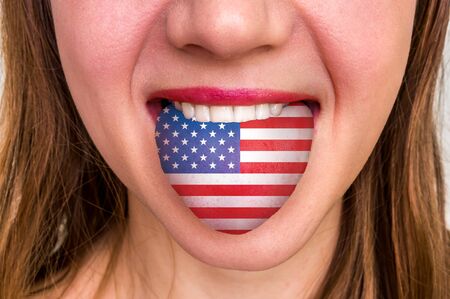 Woman with american flag on the tongue - learning a foreign languageの写真素材