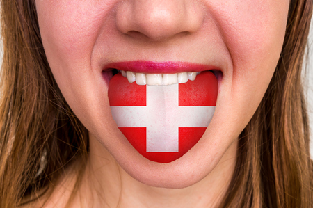 Woman with swiss flag on the tongue - learning a foreign languageの写真素材