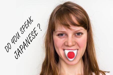 Do you speak Japanese? Woman with flag on the tongue - isolated on white backgroundの写真素材