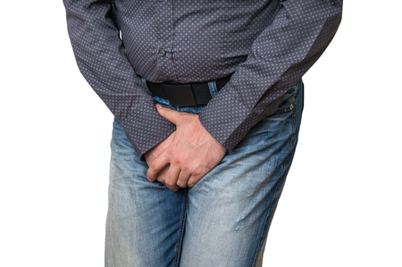 Man with hands holding his crotch, he wants to pee isolated on white - urinary incontinence conceptの写真素材