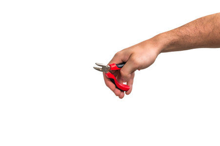 Pliers in hand of worker isolated on white backgroundの写真素材