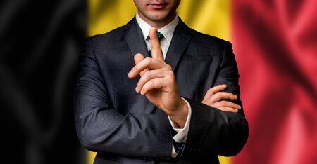 Belgian candidate speaks to the people crowd with one finger on lips - election in Belgiumの写真素材
