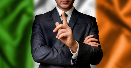 Irish candidate speaks to the people crowd with one finger on lips - election in Irelandの写真素材