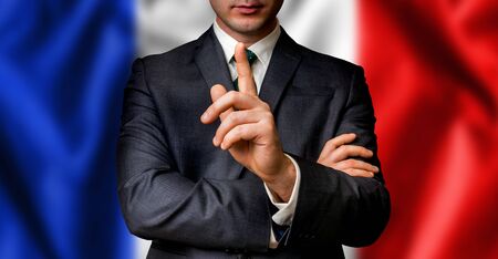 French candidate speaks to the people crowd with one finger on lips - election in Franceの写真素材
