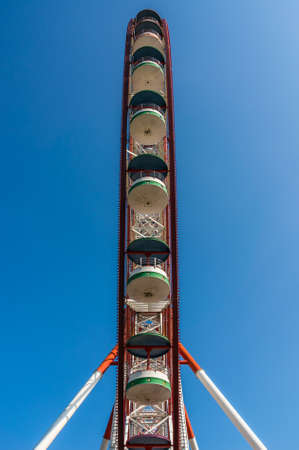 Underside view of a ferris wheel on blue sky backgroundの写真素材