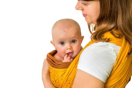 Happy mother with her baby in a sling - isolated on white backgroundの写真素材