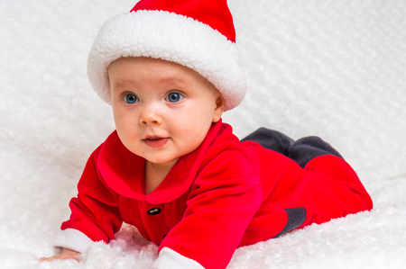 Happy little baby celebrates Christmas with Christmas costumeの写真素材