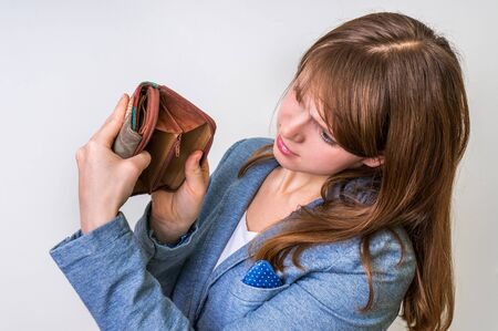 Business woman holding an empty wallet, she hasn't moneyの写真素材