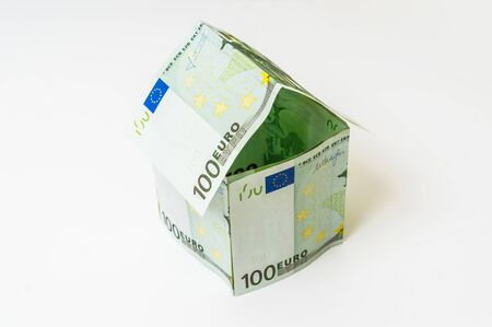 Money house made from euro banknotes on white backgroundの写真素材