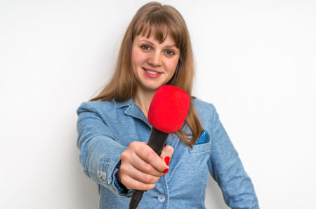Journalist with red microphone making interview - journalism and broadcasting concept