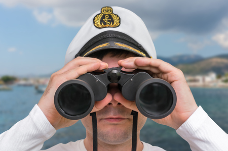 Captain looks through a binoculars - marine conceptの写真素材