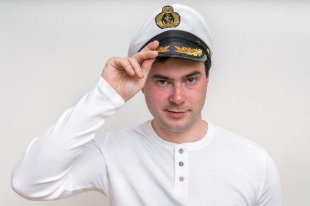 Happy captain with sailor cap isolated on white