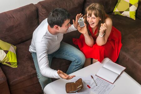 Happy young couple calculating family budget - family budget and finances conceptの写真素材