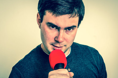 Elegant man with red microphone - party and celebration concept - retro styleの写真素材