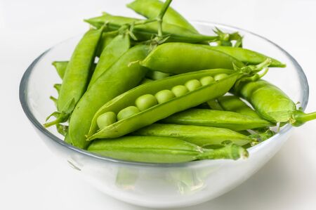 Fresh green peas in bowl - healthy food conceptの写真素材