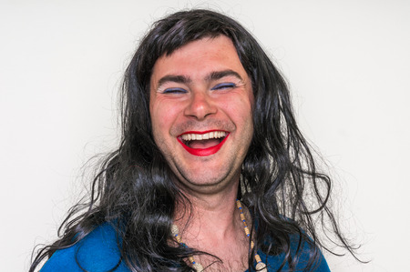 Attractive man wearing makeup and blue dress looks like as a womanの写真素材